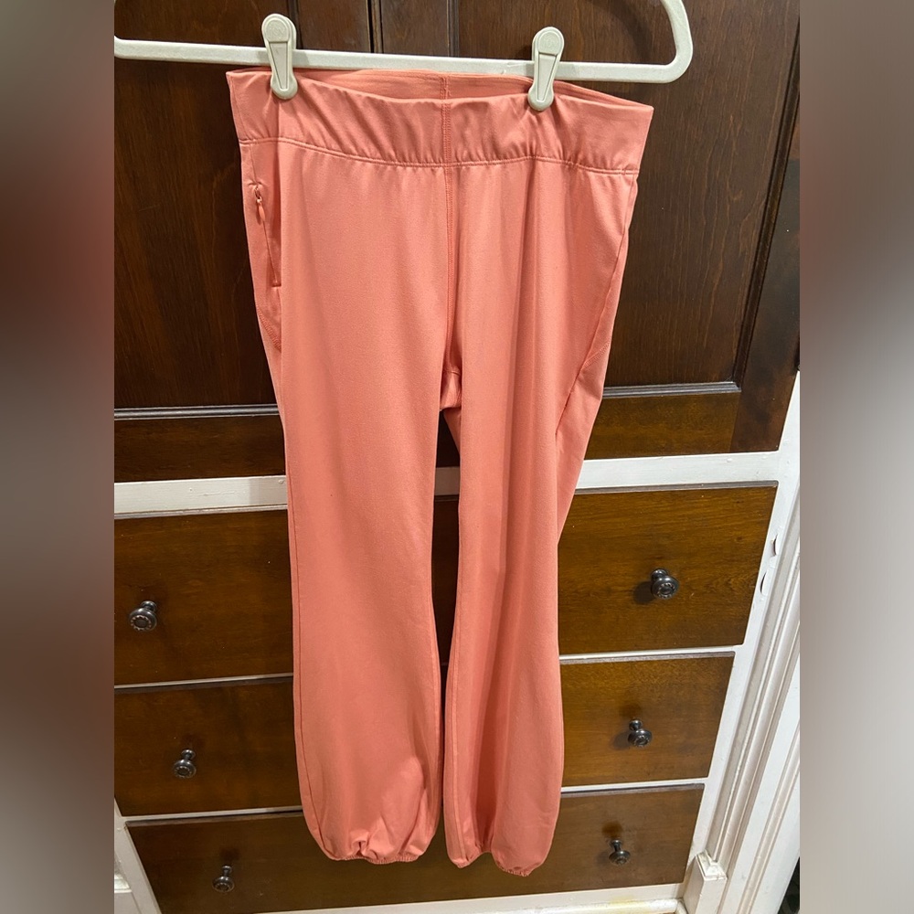 Free People Movement flare leggings with elastic bottoms in peach, size small.